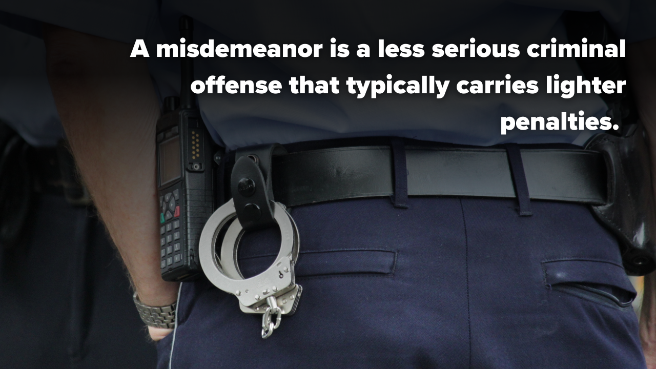 A police officer with handcuffs on their belt used to represent a misdemeanor vs. felony