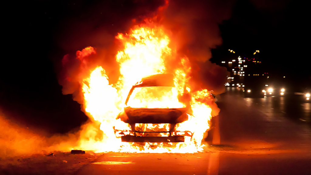 A car on far representing arson when it comes to criminal law